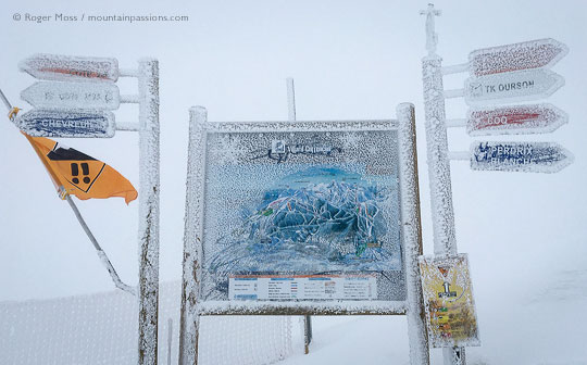 View through mist of frozen piste signage